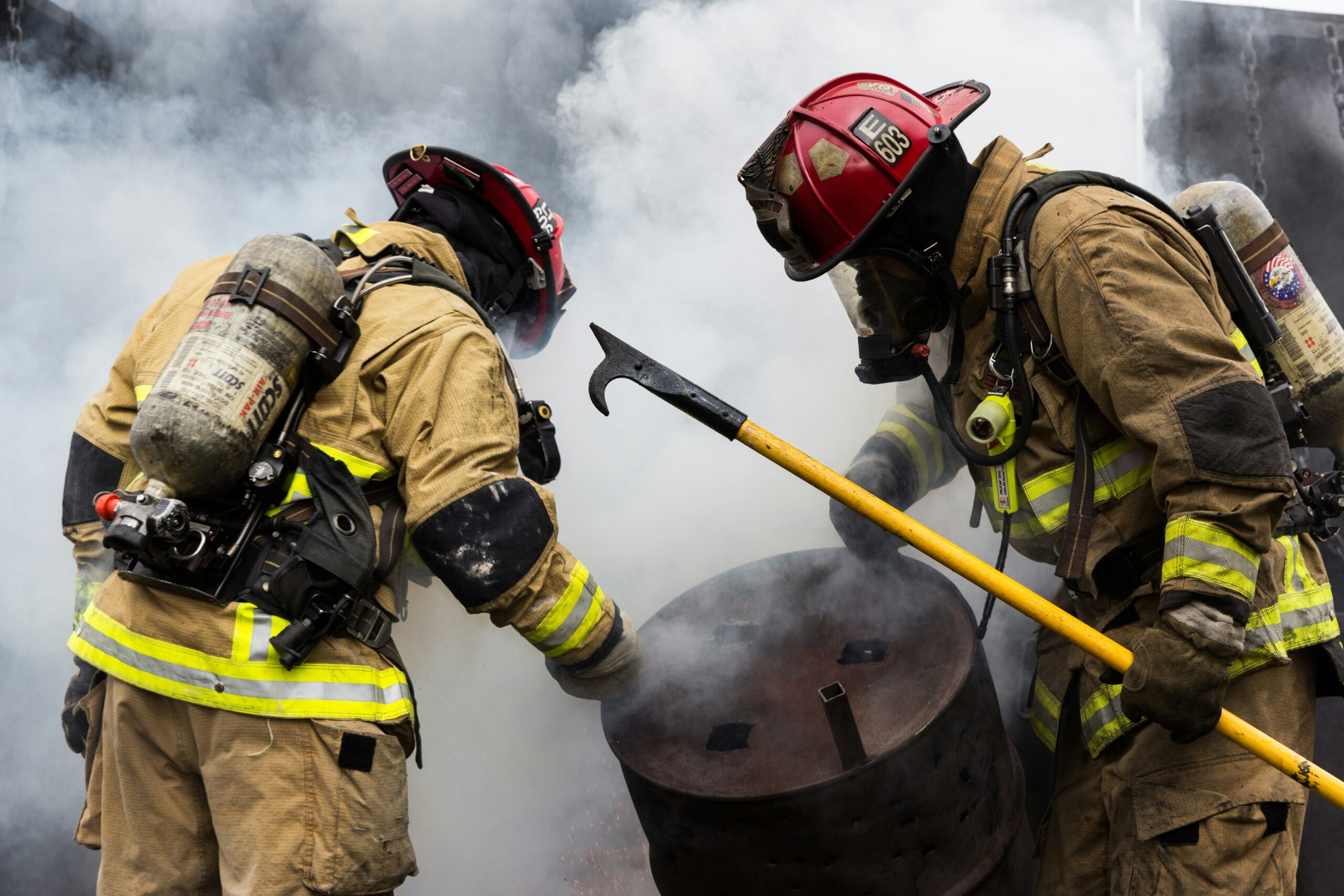 fire fighters wearing gear to protect themselves from steam. They are wearing zippers that can withstand heat.