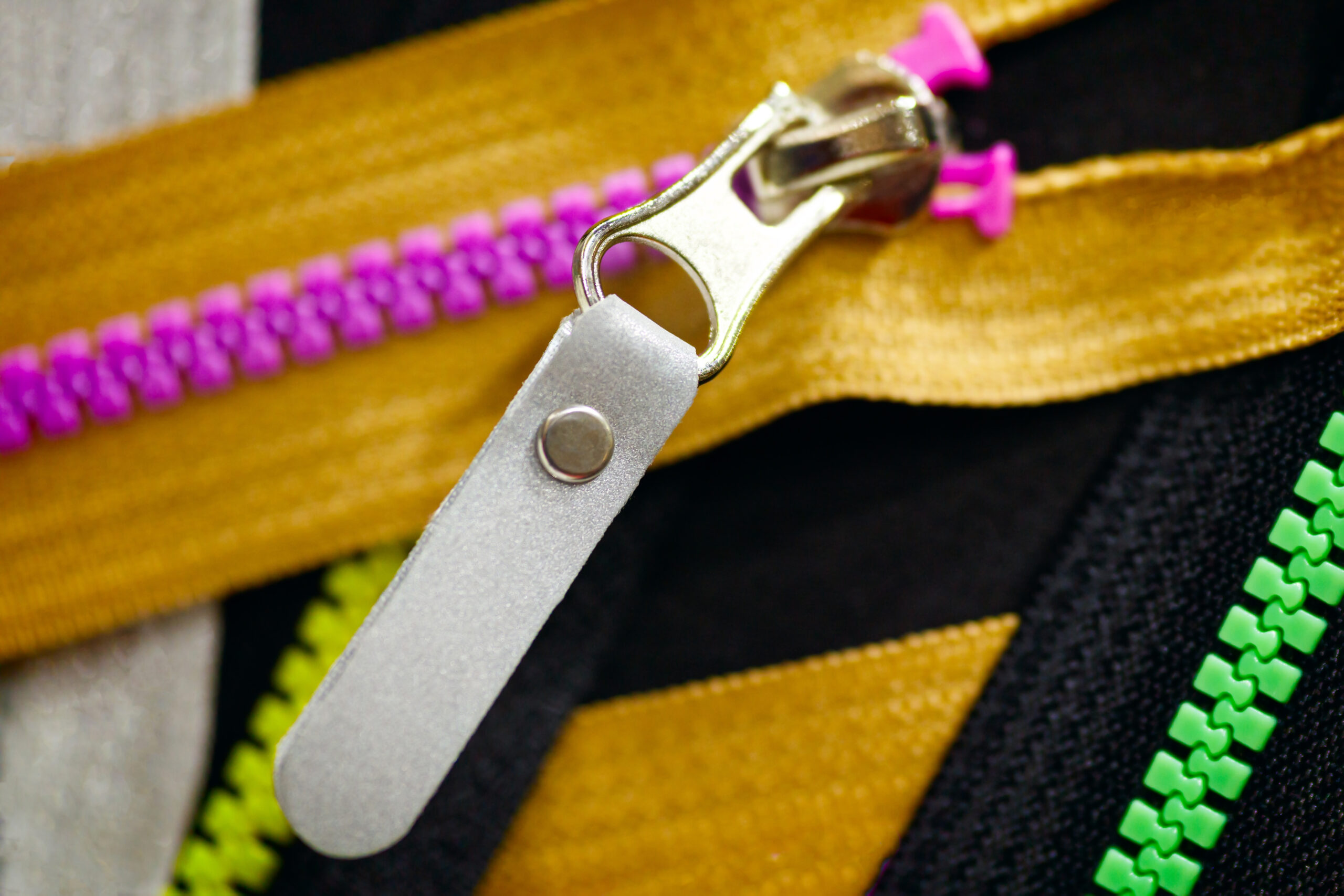 Zip background texture of zippers sliders. a lot of zippers in different colors. sewing clothes, atelier, fabric and accessories shop. hobby diy concept